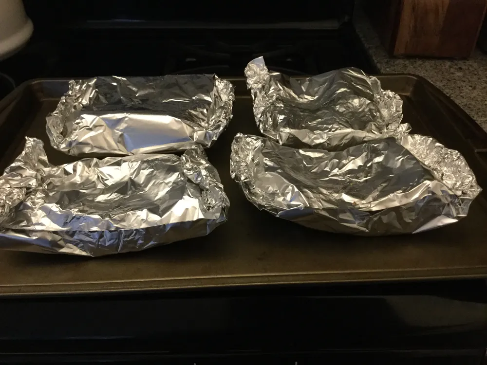 Wrap in aluminum foil and place meat side down.
